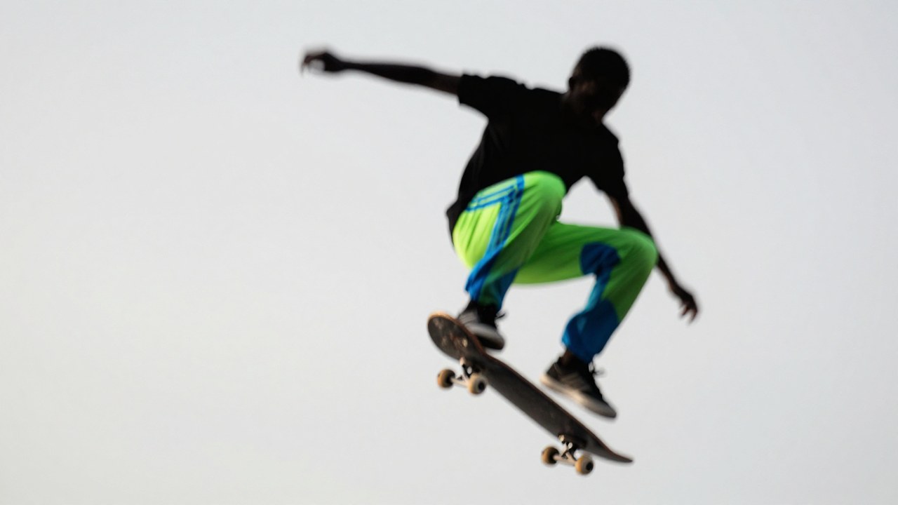 Z-Image Turbo generation: A blurred silhouette of a skateboarder midair performing a kickflip, the board is rotating…