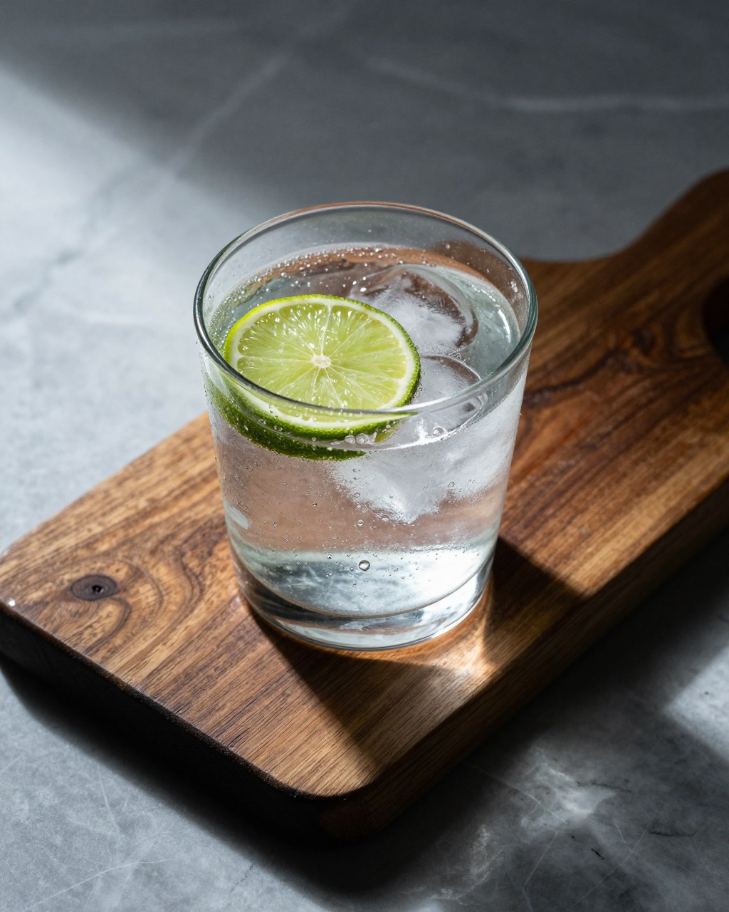 Z-Image Turbo generation: Photorealistic editorial product photography. Subject: A clear, thick-walled tumbler glass…